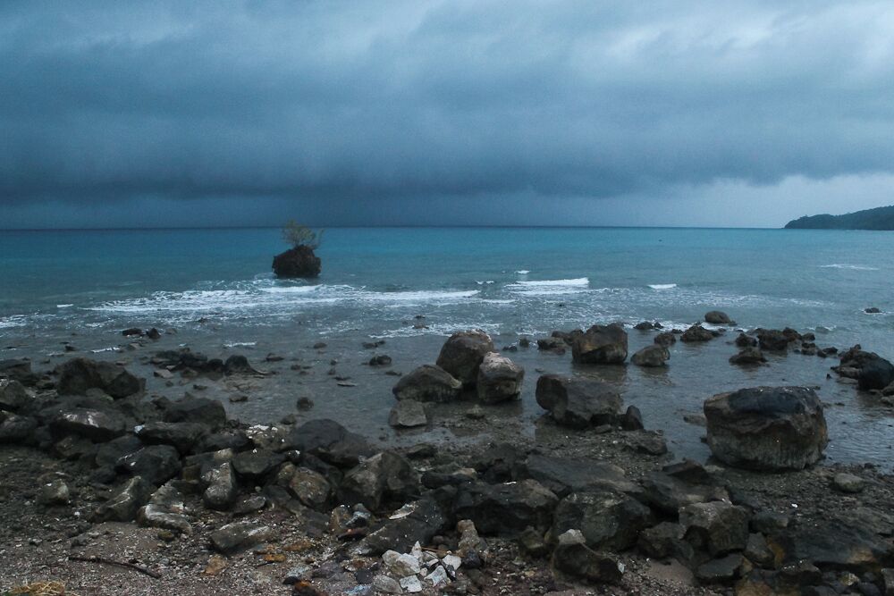 We had just finished hiking to a coastal village only accessible by foot or boat. 

Sitting on the back of motorcycle of a local I was with, I looked over to the big wide ocean and saw this storm coming.

In true "IKEA"commercial fashion, I yelled something like, "Stop the bike!!" and hopped off.

It was the most surreal moment in lots of ways. I dunno. There is something about a tropical storm, on the beach. So haunting, so alive.