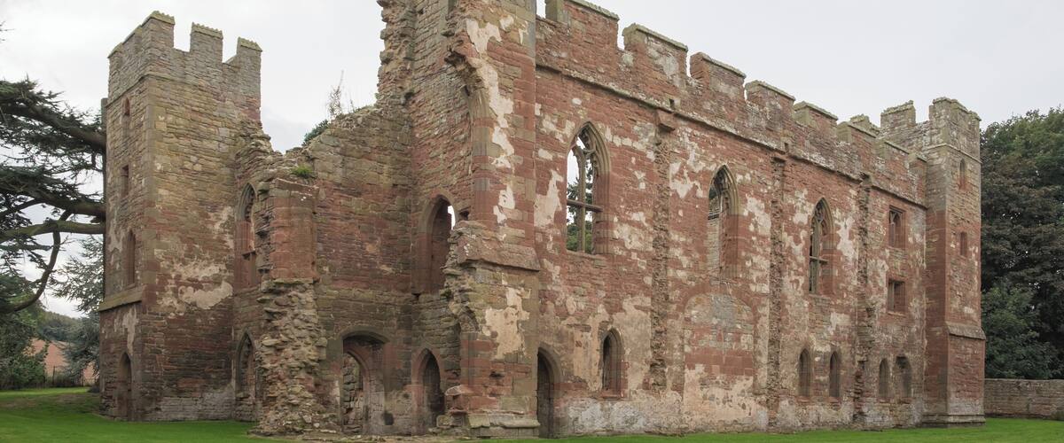 An old stone castle with arched windows and battlements.