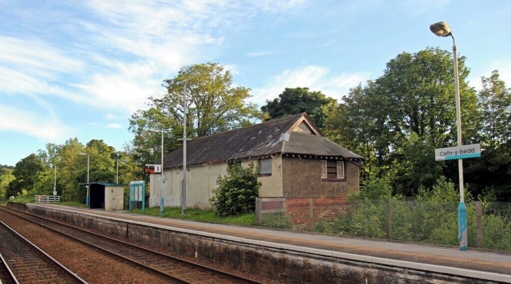A railway station with a small building labeled 'Cefn-y-bedd' and tracks.