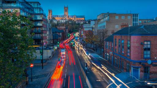 View of Lincoln Cathedral and traffic on Broadgate at dusk, Lincoln, Lincolnshire, England