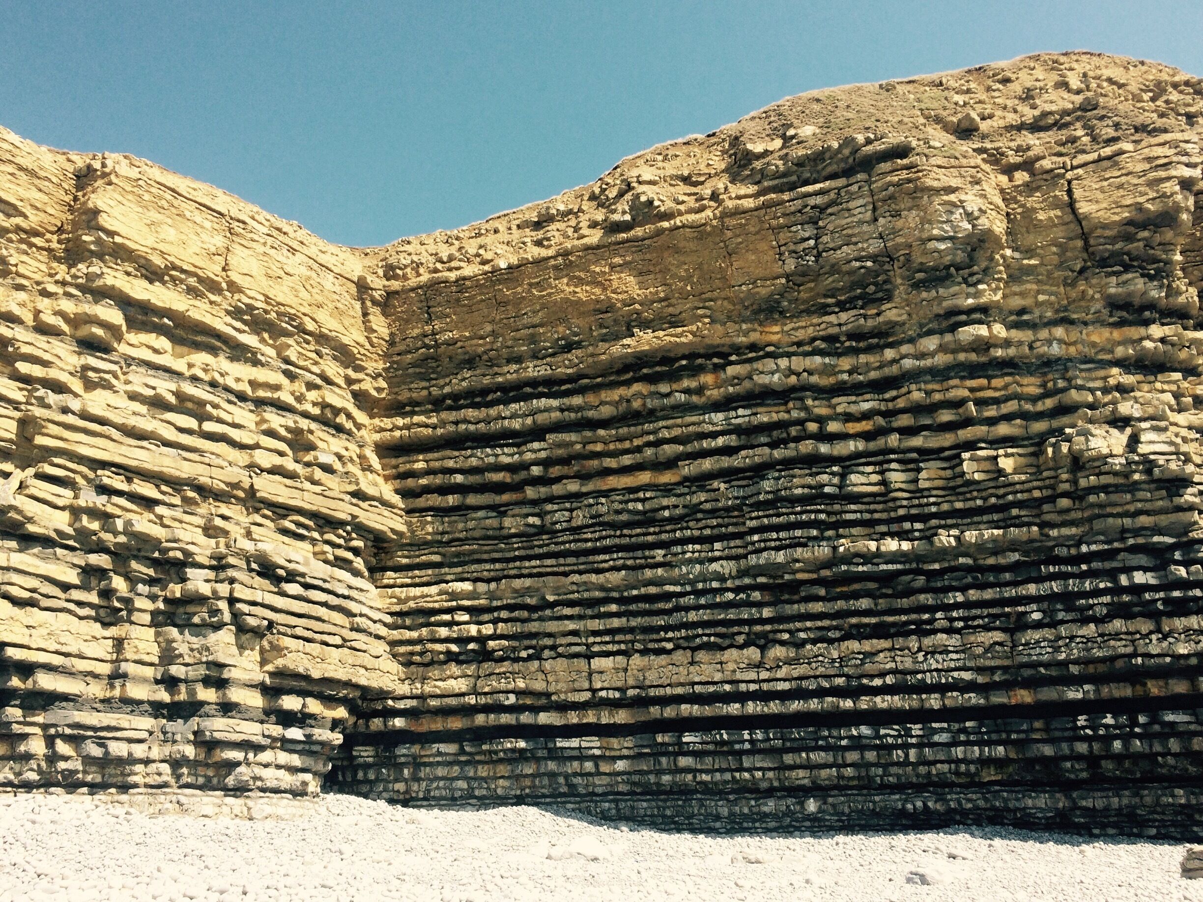 A rock formation with layered sedimentary rock.