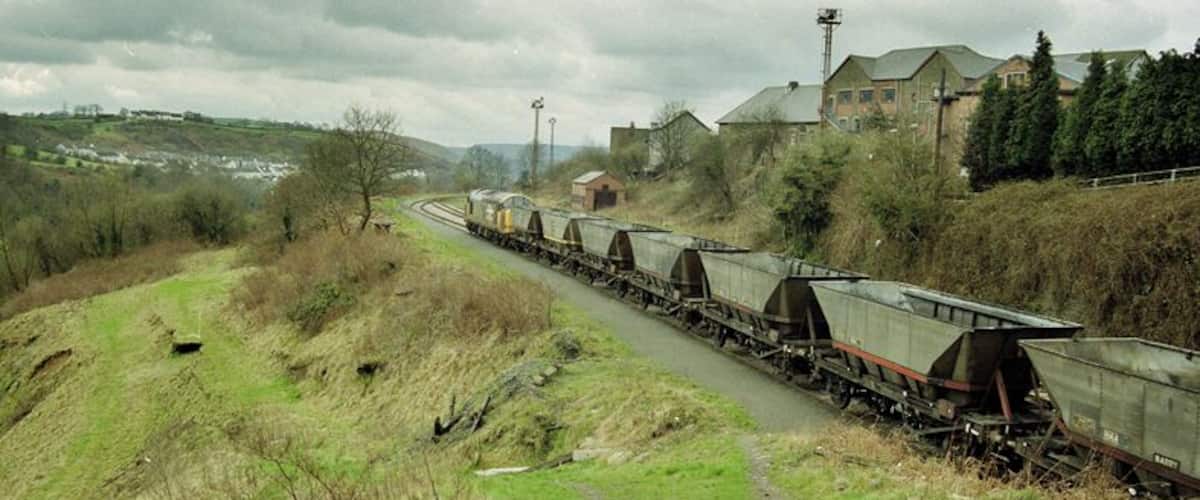 A train of empties arrives at Deep Nasvigation hauled by the imbicuous class 37.