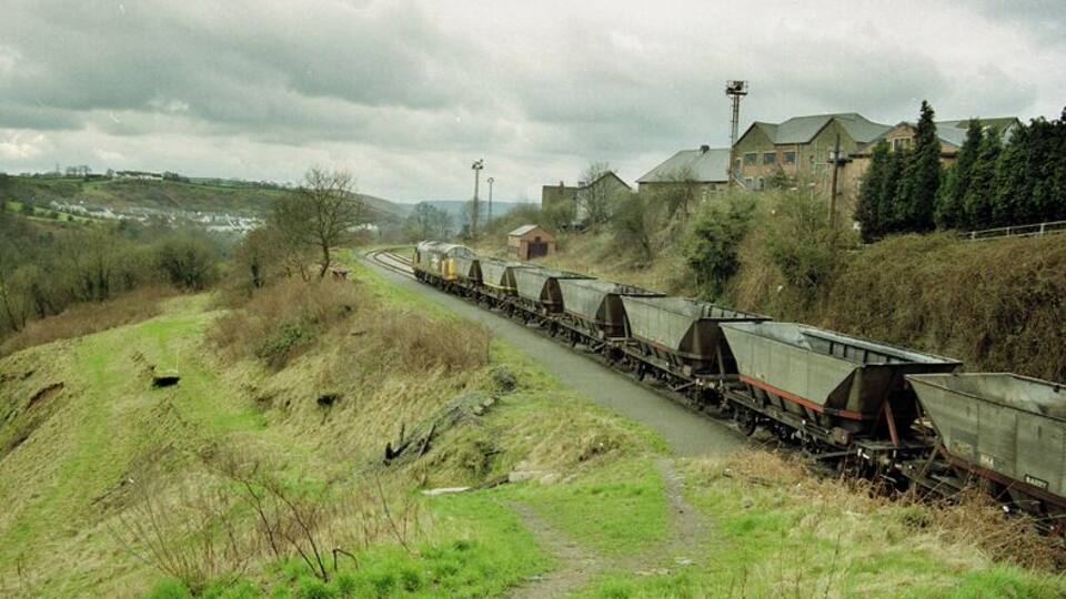 A train of empties arrives at Deep Nasvigation hauled by the imbicuous class 37.