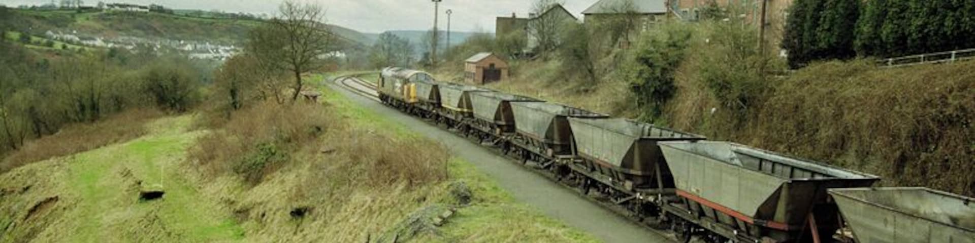 A train of empties arrives at Deep Nasvigation hauled by the imbicuous class 37.