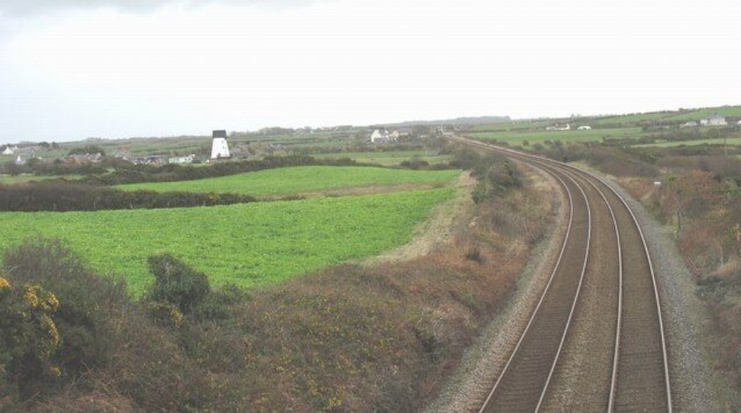 Railway line east of Glan-gors bridge Melin y Bont mill and Ty Croes Station (with the level-crossing gates open to road traffic) can be seen in the distance.