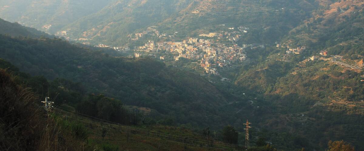 A mountainous landscape with a town nestled in the valley.