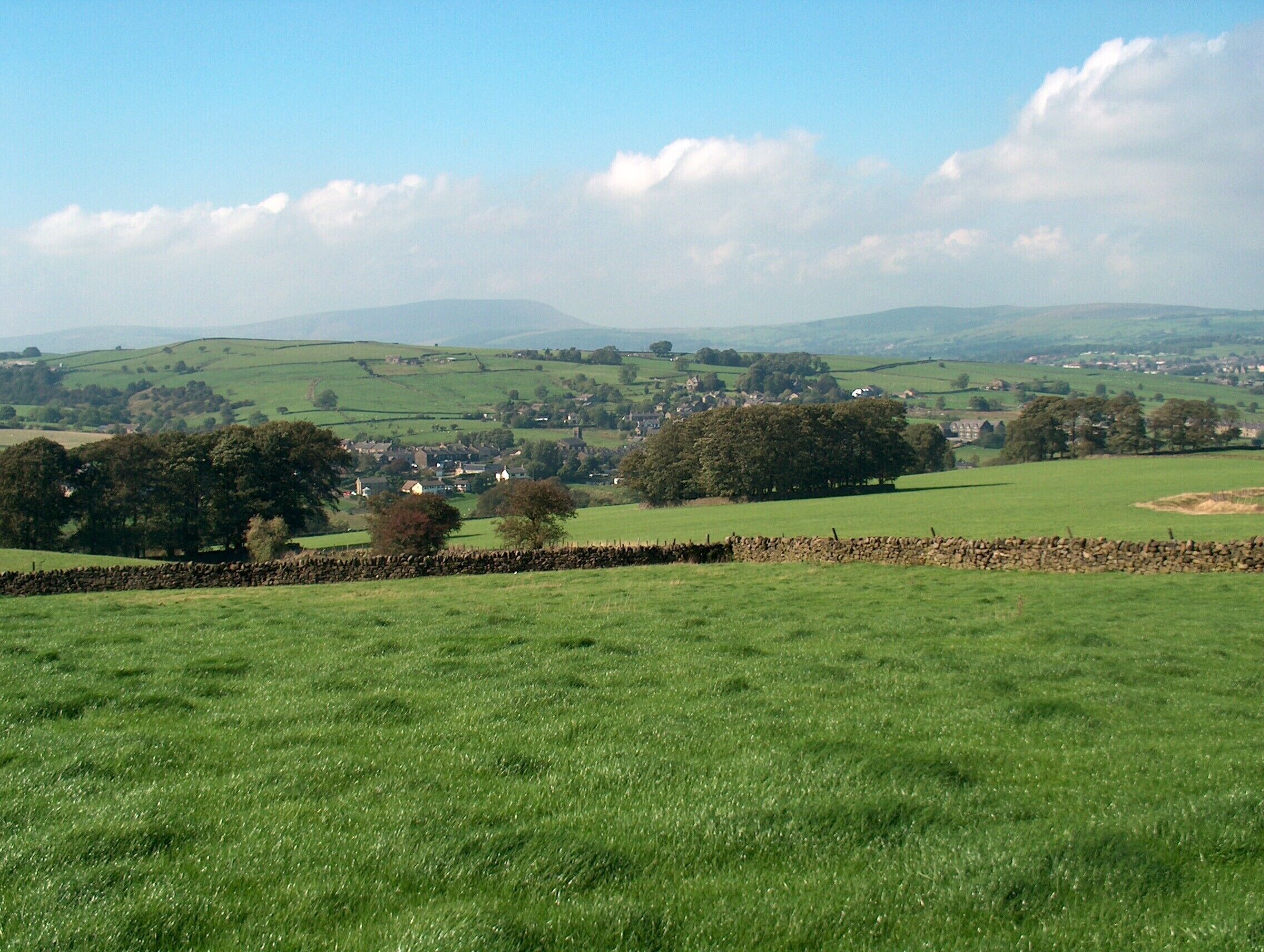 Green fields east of Trawden Trawden is down in the dip. Pendle is right in the background.