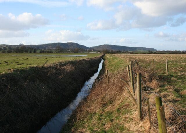 Beginnings of the River Weaver The River Weaver near its source in the Peckforton Hills (background). At this point the river is scarcely distinguished from the many drainage ditches in this area. View from footbridge by Coronation Wood