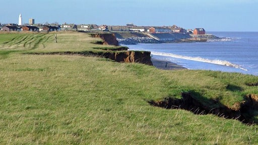 Clifftop Path south of Withernsea, East Riding of Yorkshire, England. Each year a little more falls into the sea, and each year Withernsea sticks out a little further. Note the lighthouse and church in the distance.