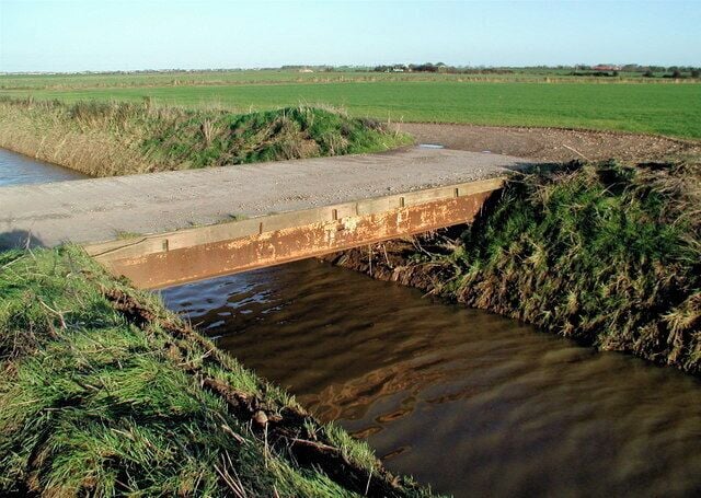 Winestead Drain and Hollym Carrs, west of Hollym, East Riding of Yorkshire, England. Looking east-northeast towards Railway Cottages at the western end of Crofts Lane, Hollym.