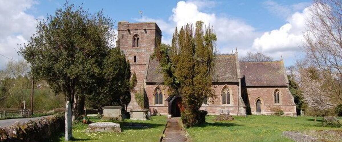 A historic church with a tall tower and arched windows.