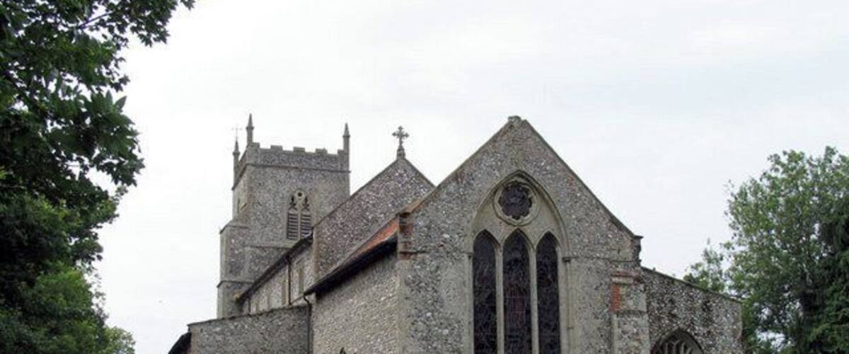 An old church with a large tower and stained glass windows.