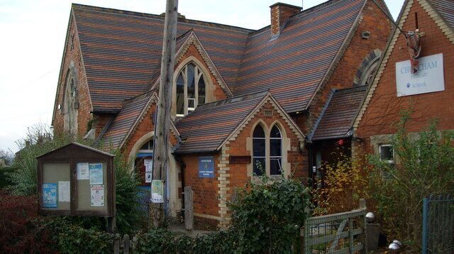 A church with a pointed roof and brick walls.