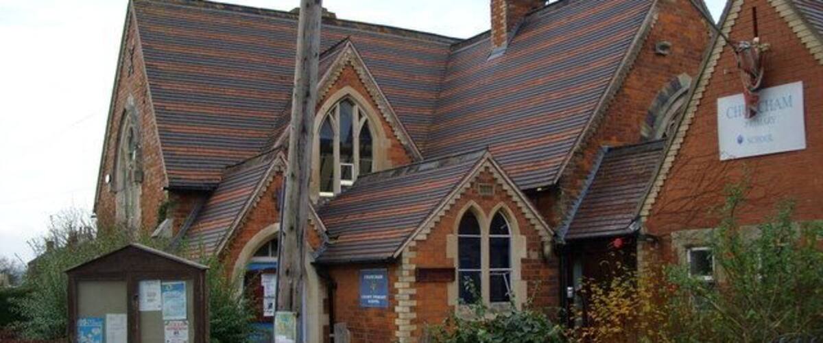 A church with a pointed roof and brick walls.