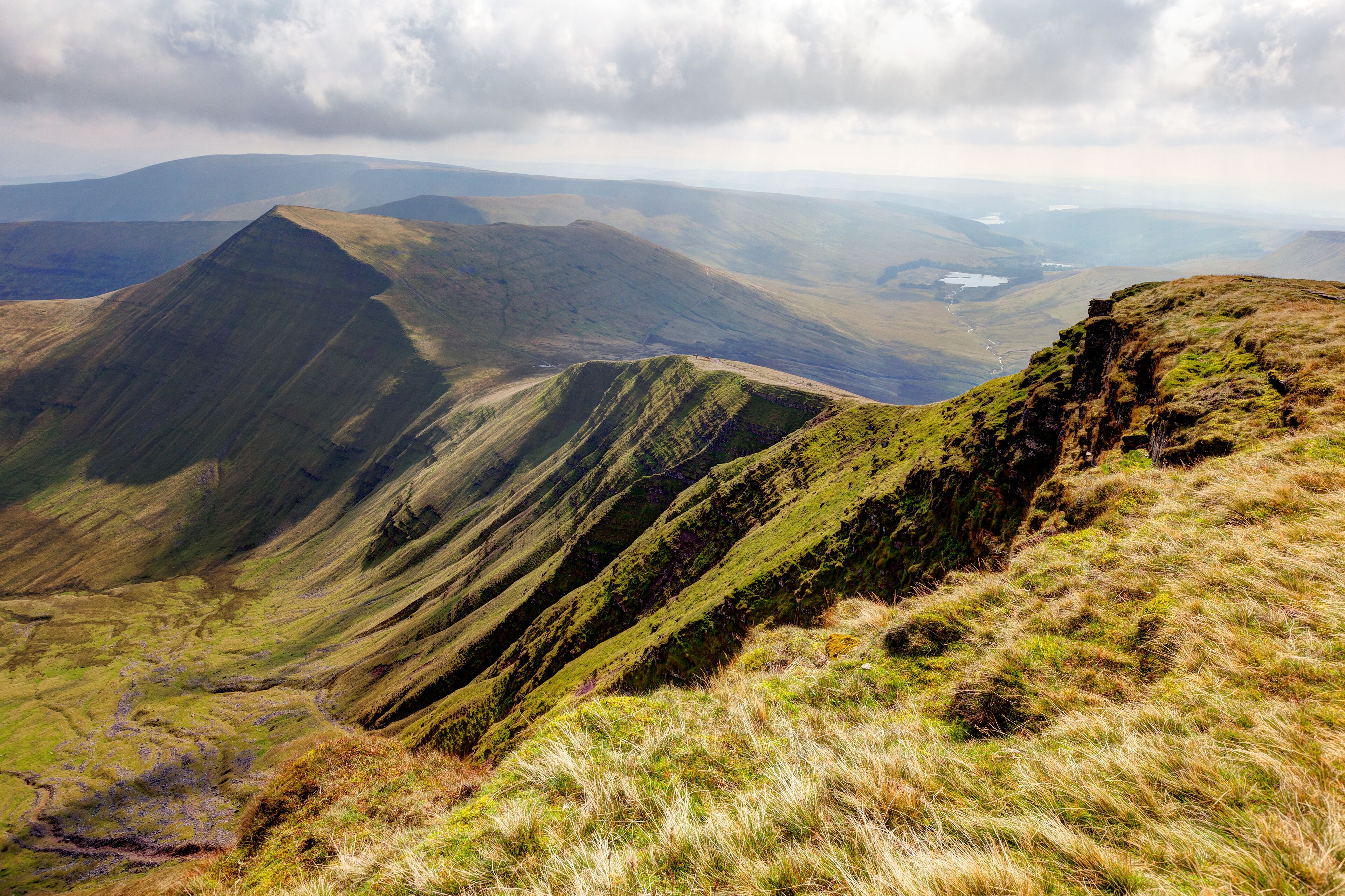 A mountainous landscape with rolling hills and a valley.