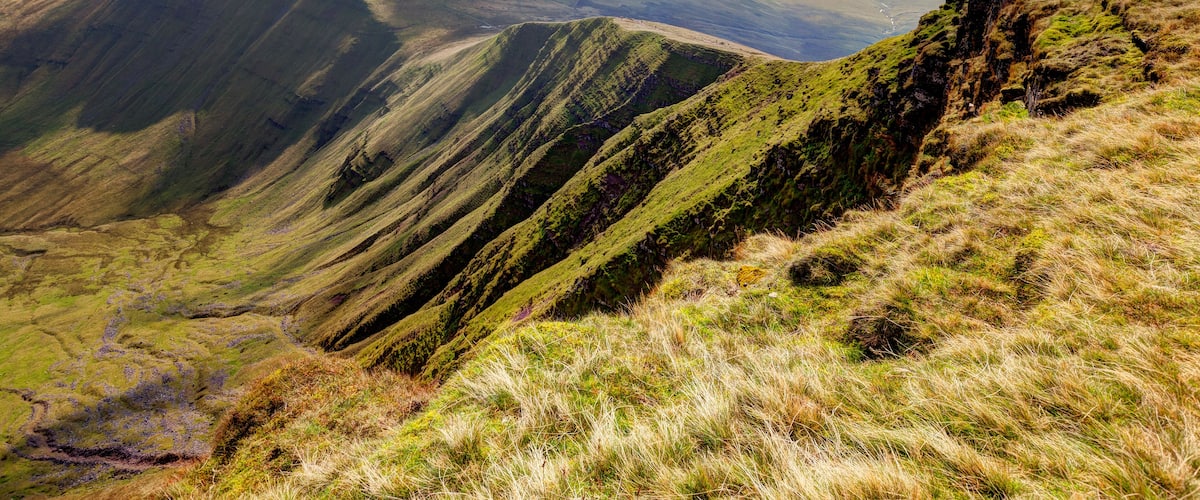 A mountainous landscape with rolling hills and a valley.
