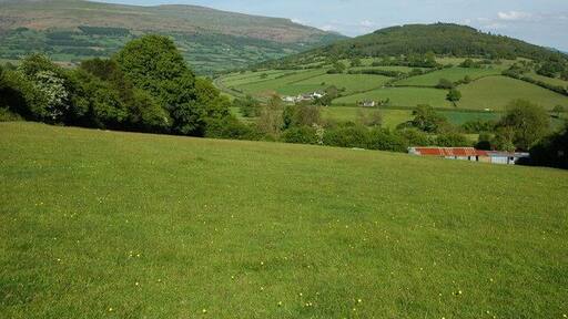 View to the east from the lower slopes of Buckland Hill View to the east from near Bwlch on the lower slopes of Buckland Hill, the wooded hill on the right is Myarth and Pen Cerrig-calch is on the horizon.
