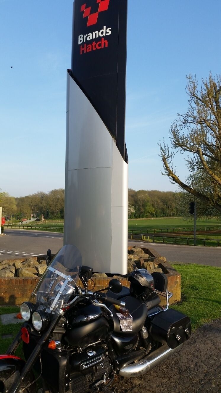 A motorcycle parked near a sign that reads "Brands Hatch".