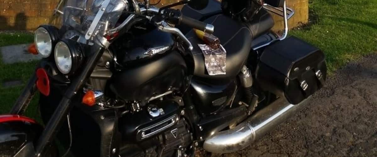 A motorcycle parked near a sign that reads "Brands Hatch".