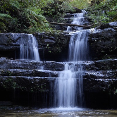 Walk down the dirt road until you see the split in the road with a sign. Head towards the falls loop by going down a pathway. Along this walk you'll come across many waterfalls and swimming pools. It's magic.