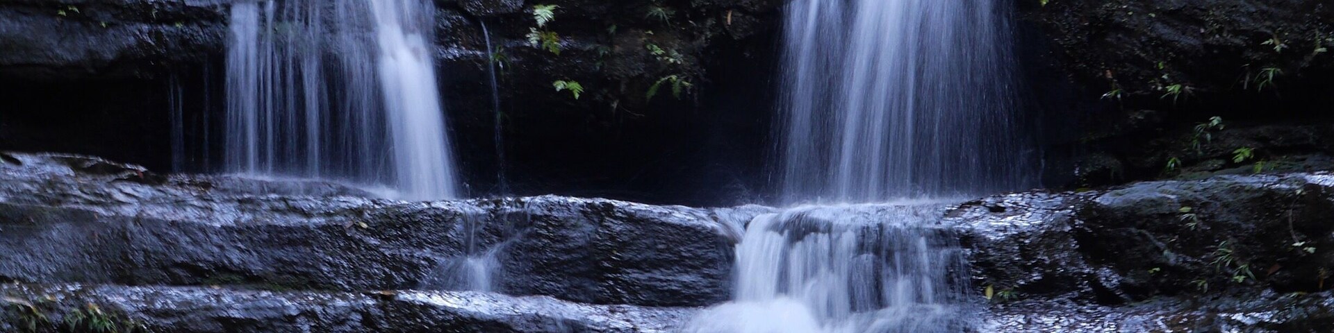 Walk down the dirt road until you see the split in the road with a sign. Head towards the falls loop by going down a pathway. Along this walk you'll come across many waterfalls and swimming pools. It's magic.
