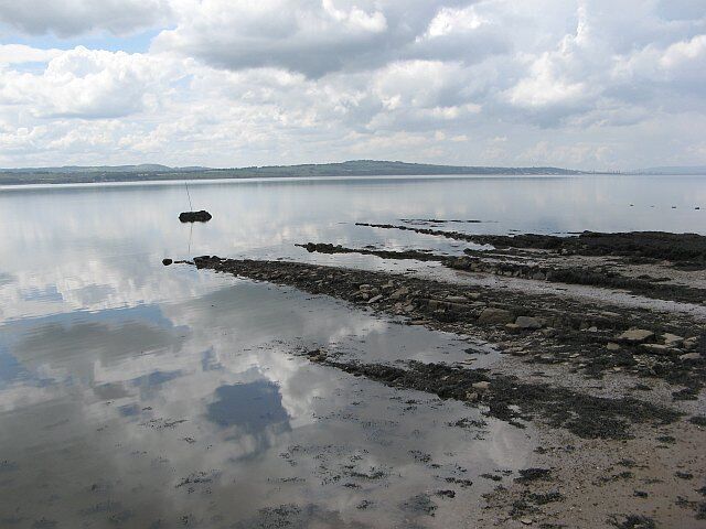 Rocks off Limekilns Rocks drying at low water, seen from the pier at Bruce Haven.