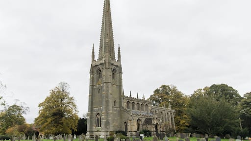 Described as “without doubt one of the most glorious of all Lincolnshire churches…like a medieval dream”. Much of the credit for this beauty must go to Canon Frederick Heathcote Sutton, who was Rector from 1873 to 1888, and in partnership with the architect G.F.Bodley (1827-1907) he carried out an extensive programme of rebuilding and restoration, mainly between 1874 and 1876. The roof-line of the 13th century church is still visible on the wall of the tower arch, and the Decorated style west windows in the aisles were also part of this building. In the next century came the lower part of the tower and the arcades with their octagonal pillars. The crocketed spire, 198 feet high, is a landmark for many miles Two fragments of a stone effigy, comprising the robed torso of a priest and a hand holding a chalice, were found beneath the floor at the base of the tower, and Canon Sutton thought they might have come from the tomb of John Torald (Thorold) who was Rector here from 1457 to 1468. The clerestory and the fine roof were added in the 15th century and are Late Perpendicular. From the central aisle it is interesting to compare the roofs, doors and early Perpendicular windows of the side aisles. Although they appear identical at first sight, their style and decoration differ in several respects, the south side having been built later than the north aisle. During the Bodley restoration the bowl of the old font was re-worked, decorated with sunk panels and carving and set on a new shaft and base. The font cover was designed by Thomas Garner. Its decoration echoes the crockets and pinnacles on the spire of the church. The cover opens to reveal a painted interior, and carved figures of St Michael, St Nicholas and St Agnes. The Rood screen and choir stalls were erected in 1890 by Canon Arthur Sutton. The figure of the crucified Christ was added in 1919. The chancel arch marks the beginning of the re-building undertaken in 1874, when the chancel of 1812 was demolished and replaced by the present structure. The north-east aisle and the vestries were also built then, in part on pre-1812 foundations. The Gothic design of the chancel blends perfectly with the ancient church to which it was added. Canon Sutton designed the Reredos installed in 1887 and gave the painted panel depicting the Ascension which is its centrepiece. This, part of a polytych, dates from about 1490 and is the work of the artist known as the Master of Liesborn. The reredos, with its carvings of the four Evangelists and its rich gilding, was inspired by medieval German work. The ceilings of the chancel and the choir aisle are outstanding examples of High Victorian design by a great architect. During the demolition of the old chancel some long and short work from the original Saxon church was uncovered at the north-east angle of the nave. Other finds included a piece of interlaced Saxon stonework. Fragments of monuments of the Daubney family (Lords of the Manor in the 13th and 14th centuries) were found in the old walls and later reconstructed to form the table tomb in the north east aisle. On the south side of the church are two sundials, one in the angle of the buttresses at the south-east corner of the nave and the other between the south-east buttresses on the wall of the tower. The porches, dating from the late 14th century, both have fine stone vaulted roofs. Like the aisles they are similar, but not identical and both have a number of interesting carvings. (Condensed from Church Guide) Pic by Jenny.