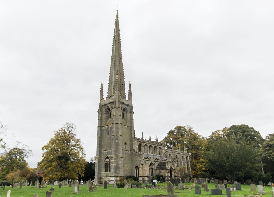 Described as “without doubt one of the most glorious of all Lincolnshire churches…like a medieval dream”. Much of the credit for this beauty must go to Canon Frederick Heathcote Sutton, who was Rector from 1873 to 1888, and in partnership with the architect G.F.Bodley (1827-1907) he carried out an extensive programme of rebuilding and restoration, mainly between 1874 and 1876. The roof-line of the 13th century church is still visible on the wall of the tower arch, and the Decorated style west windows in the aisles were also part of this building. In the next century came the lower part of the tower and the arcades with their octagonal pillars. The crocketed spire, 198 feet high, is a landmark for many miles Two fragments of a stone effigy, comprising the robed torso of a priest and a hand holding a chalice, were found beneath the floor at the base of the tower, and Canon Sutton thought they might have come from the tomb of John Torald (Thorold) who was Rector here from 1457 to 1468. The clerestory and the fine roof were added in the 15th century and are Late Perpendicular. From the central aisle it is interesting to compare the roofs, doors and early Perpendicular windows of the side aisles. Although they appear identical at first sight, their style and decoration differ in several respects, the south side having been built later than the north aisle. During the Bodley restoration the bowl of the old font was re-worked, decorated with sunk panels and carving and set on a new shaft and base. The font cover was designed by Thomas Garner. Its decoration echoes the crockets and pinnacles on the spire of the church. The cover opens to reveal a painted interior, and carved figures of St Michael, St Nicholas and St Agnes. The Rood screen and choir stalls were erected in 1890 by Canon Arthur Sutton. The figure of the crucified Christ was added in 1919. The chancel arch marks the beginning of the re-building undertaken in 1874, when the chancel of 1812 was demolished and replaced by the present structure. The north-east aisle and the vestries were also built then, in part on pre-1812 foundations. The Gothic design of the chancel blends perfectly with the ancient church to which it was added. Canon Sutton designed the Reredos installed in 1887 and gave the painted panel depicting the Ascension which is its centrepiece. This, part of a polytych, dates from about 1490 and is the work of the artist known as the Master of Liesborn. The reredos, with its carvings of the four Evangelists and its rich gilding, was inspired by medieval German work. The ceilings of the chancel and the choir aisle are outstanding examples of High Victorian design by a great architect. During the demolition of the old chancel some long and short work from the original Saxon church was uncovered at the north-east angle of the nave. Other finds included a piece of interlaced Saxon stonework. Fragments of monuments of the Daubney family (Lords of the Manor in the 13th and 14th centuries) were found in the old walls and later reconstructed to form the table tomb in the north east aisle. On the south side of the church are two sundials, one in the angle of the buttresses at the south-east corner of the nave and the other between the south-east buttresses on the wall of the tower. The porches, dating from the late 14th century, both have fine stone vaulted roofs. Like the aisles they are similar, but not identical and both have a number of interesting carvings. (Condensed from Church Guide) Pic by Jenny.