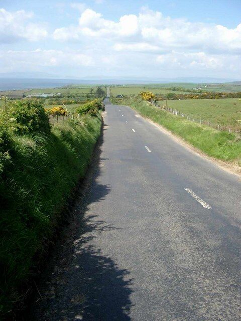 The straight to Kilmory Arran is not noted for straight roads. This is straight for over a mile - at least in two dimensions. The Mull of Kintyre can be seen faintly in the distance, over Kilbrannan Sound