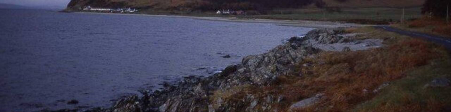 Shoreline at Catacol Bay Looking northwards across the bay to Catacol hamlet which is dwarfed by Cnoc Leacainn Duibne.