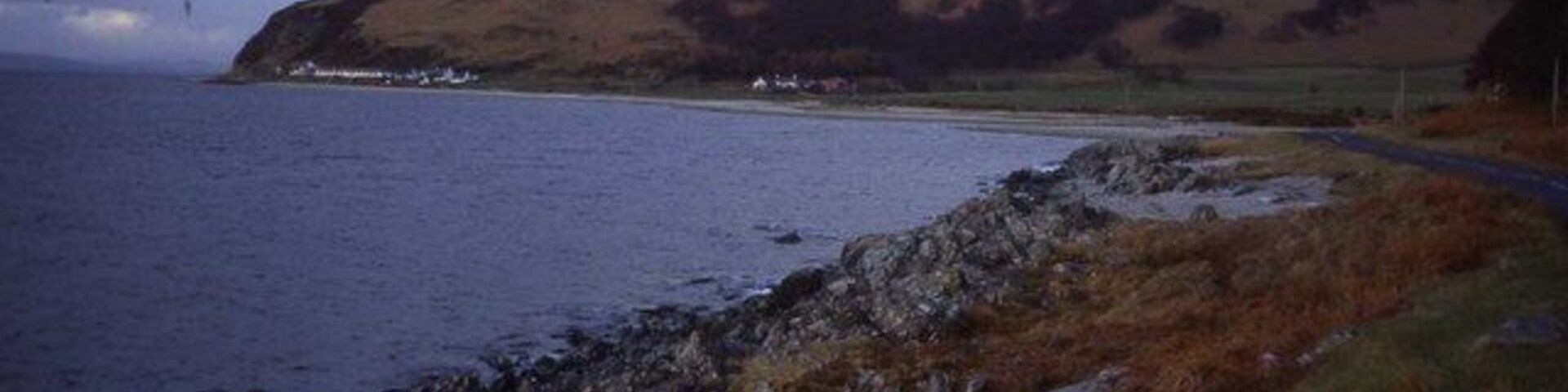 Shoreline at Catacol Bay Looking northwards across the bay to Catacol hamlet which is dwarfed by Cnoc Leacainn Duibne.