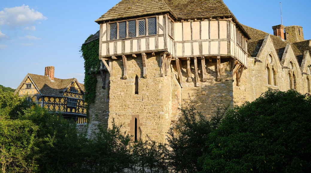 A historic half-timbered building with a steeply pitched roof and a small tower.