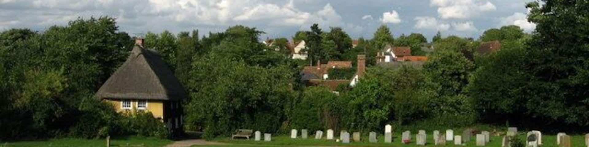 View from the church The church of St Botolph is approached via a narrow lane bordered by cottages and a hedgerow.