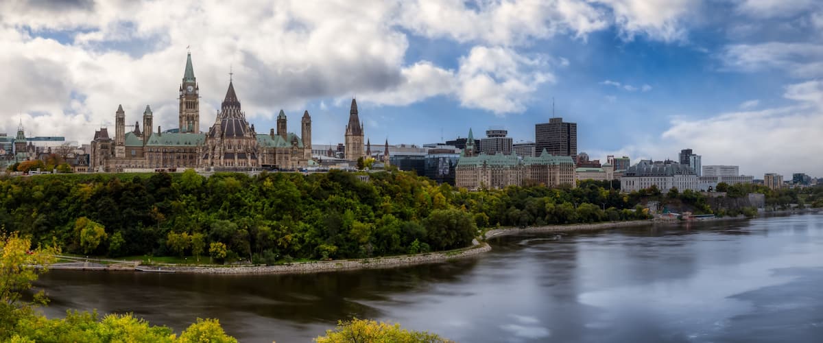 A historic cityscape with a prominent cathedral, a river, and modern buildings.