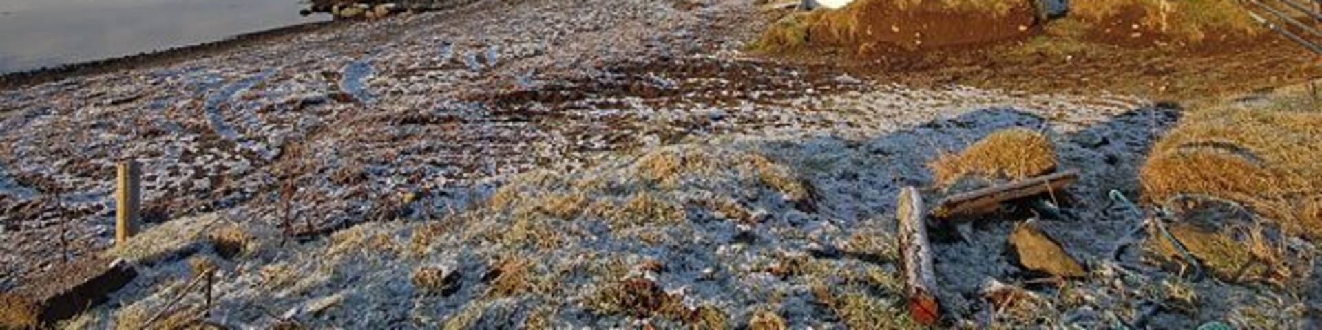 Shoreline of Loch Snizort Beag The shadows are still long approaching midday in midwinter. The salt water of the loch was carrying small floes heading north with the ebbing tide.