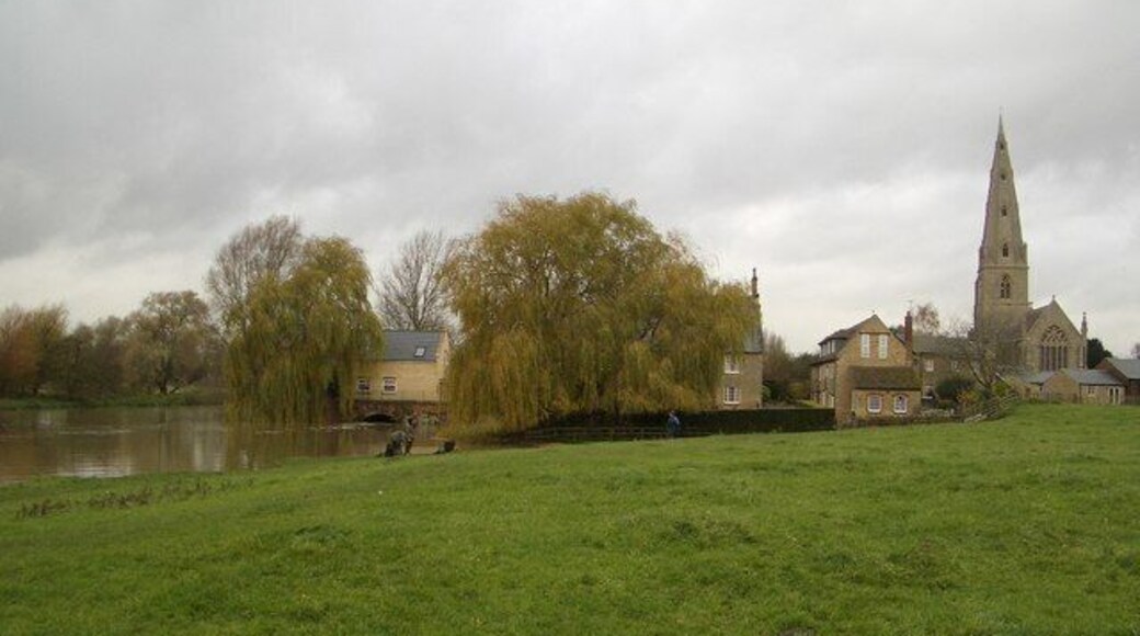The Old Mill at Olney This view shows the setting of the Mill House behind the willow tree and beside the swollen River Great Ouse at Olney. The nearby church of St Peter & St Paul is also visible. The mill itself burnt down on 16 November 1964 and was previously destroyed by fire on 3 January 1878.