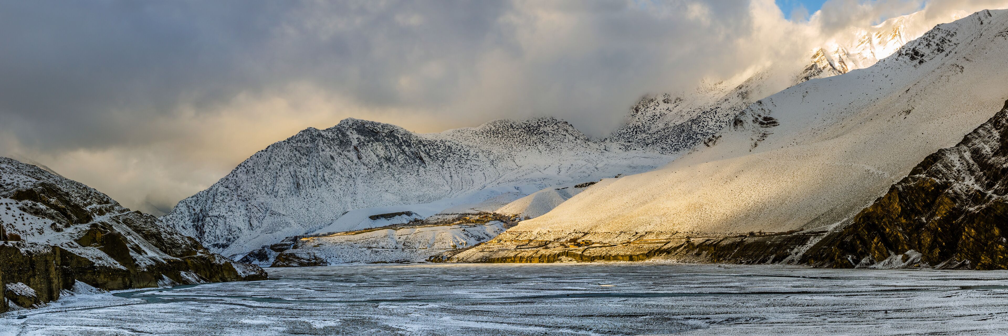 Panoramic view of the Kali Gandaki river valley near Jomsom village in cloudy winter day after snowfall. View from trekking route from Kagbeni to Jomsom.