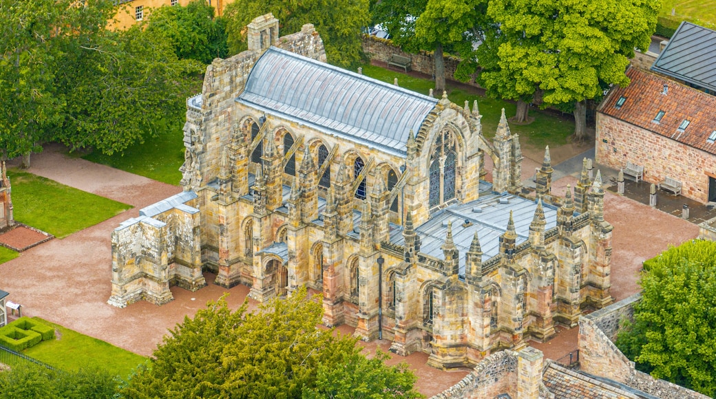 An aerial view of a historic stone church with a large, arched roof and multiple spires.