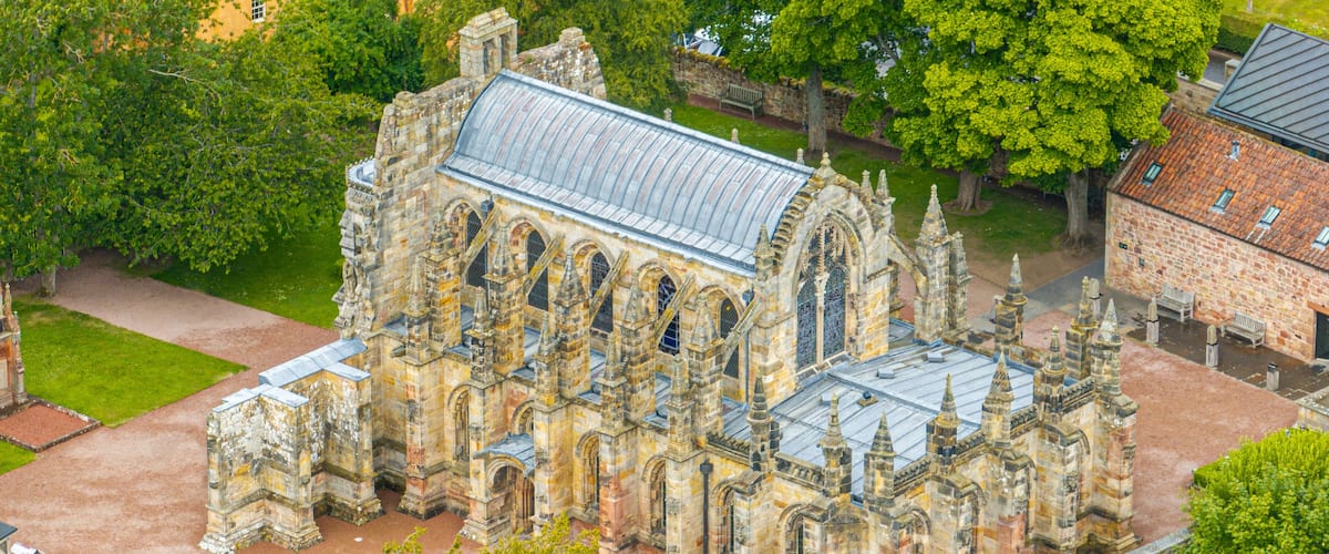 Aerial view of Rosslyn Chapel, it was founded in 1446 by Sir William St Clair. Rural Midlothian. Da Vinci Code movie. Ley lines and rose line. Edinburgh. Scotland. UK
