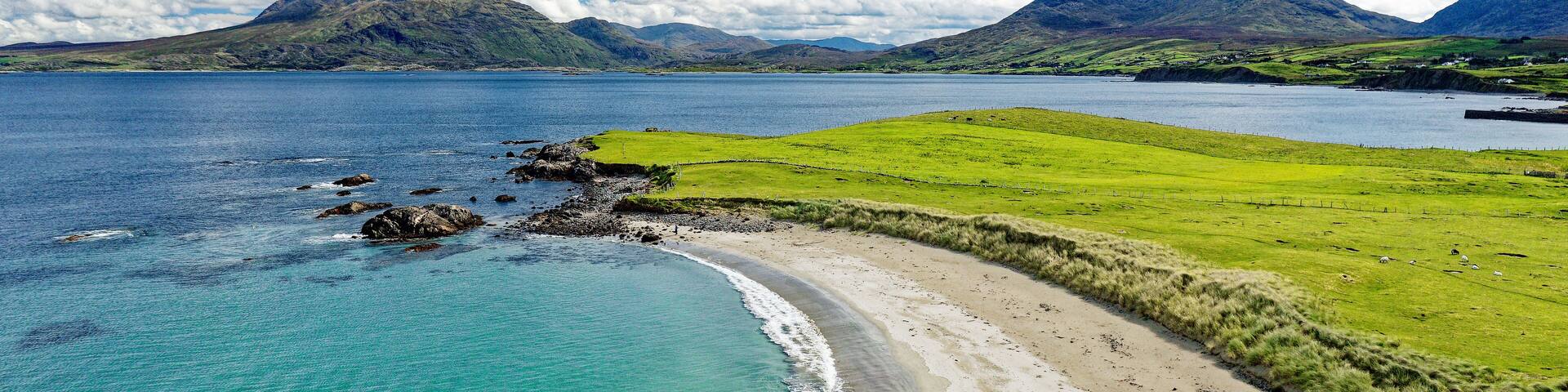Renvyle Beach, at Tully Cross, north Connemara, Ireland. Looking east to Mweelrea mountains, left, beyond mouth of Killary Harbour