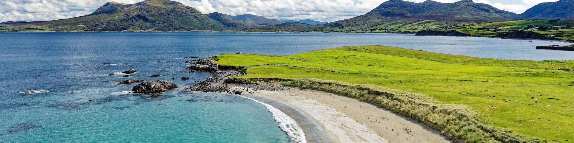 Renvyle Beach, at Tully Cross, north Connemara, Ireland. Looking east to Mweelrea mountains, left, beyond mouth of Killary Harbour