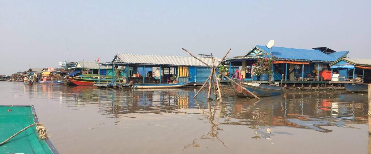 A waterway with floating houses and boats.