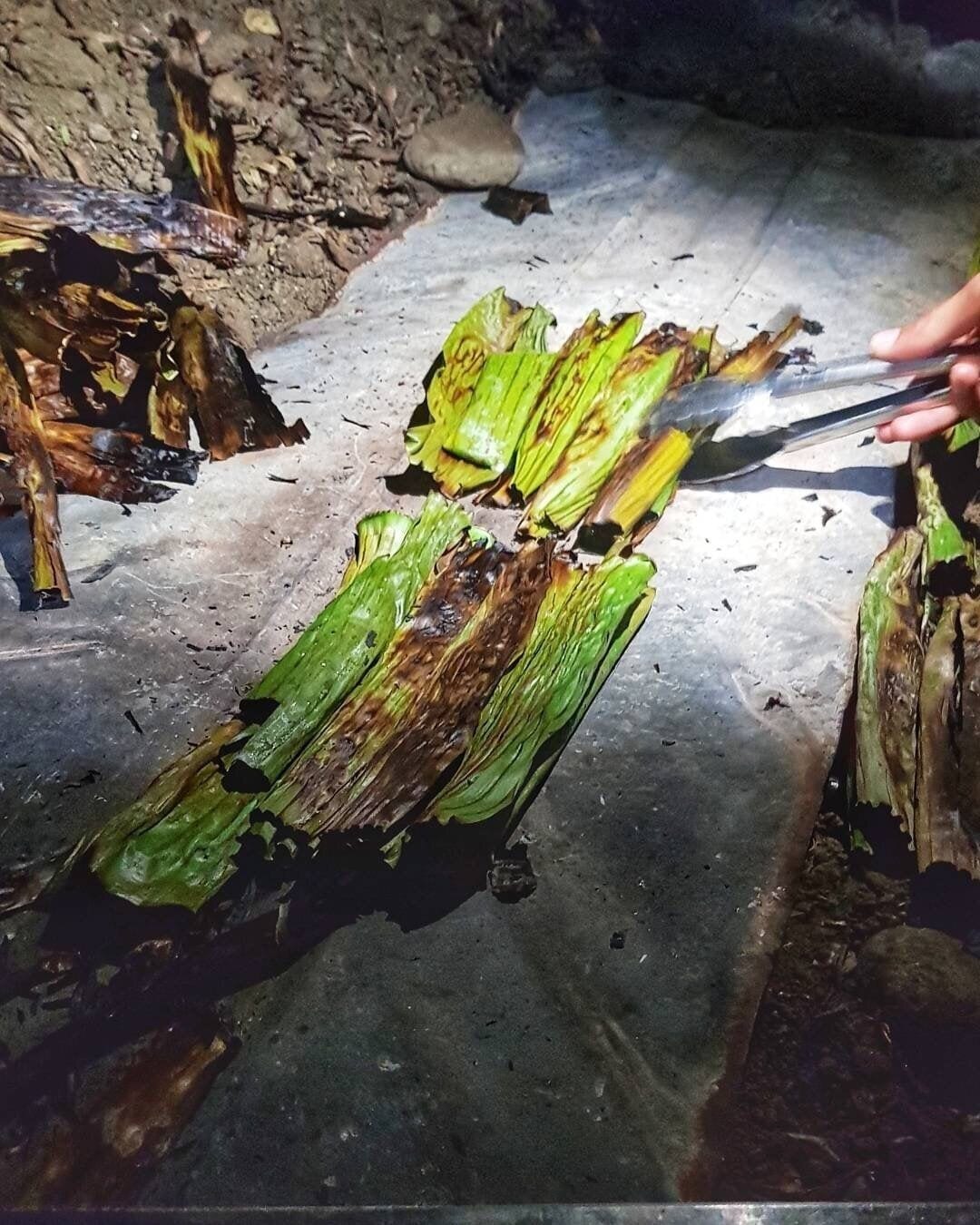 This native delicacy is very popular in Ilocos Region, Philippines. Its a kind of Snack or can be a dessert made of glutinous rice, coconut milk, molasses, grated young coconut with sesame seads and wrapped in banana leaves. Its cooked in a traditional way, and its usually prepared during Christmas time and New Years Eve. Picture was taken during the Farmers Festival native delicacy cooking contest  but this can be bought at the Batac Market. #LikeALocal #nativedelicacy #Mochi/Tupig