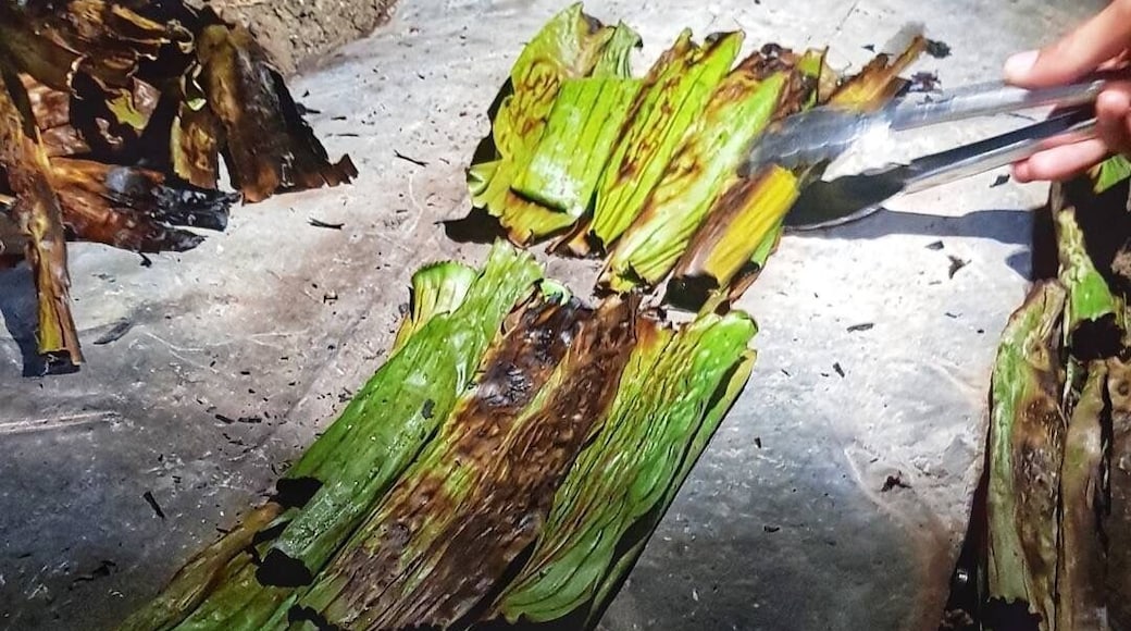 This native delicacy is very popular in Ilocos Region, Philippines. Its a kind of Snack or can be a dessert made of glutinous rice, coconut milk, molasses, grated young coconut with sesame seads and wrapped in banana leaves. Its cooked in a traditional way, and its usually prepared during Christmas time and New Years Eve. Picture was taken during the Farmers Festival native delicacy cooking contest but this can be bought at the Batac Market. #LikeALocal #nativedelicacy #Mochi/Tupig