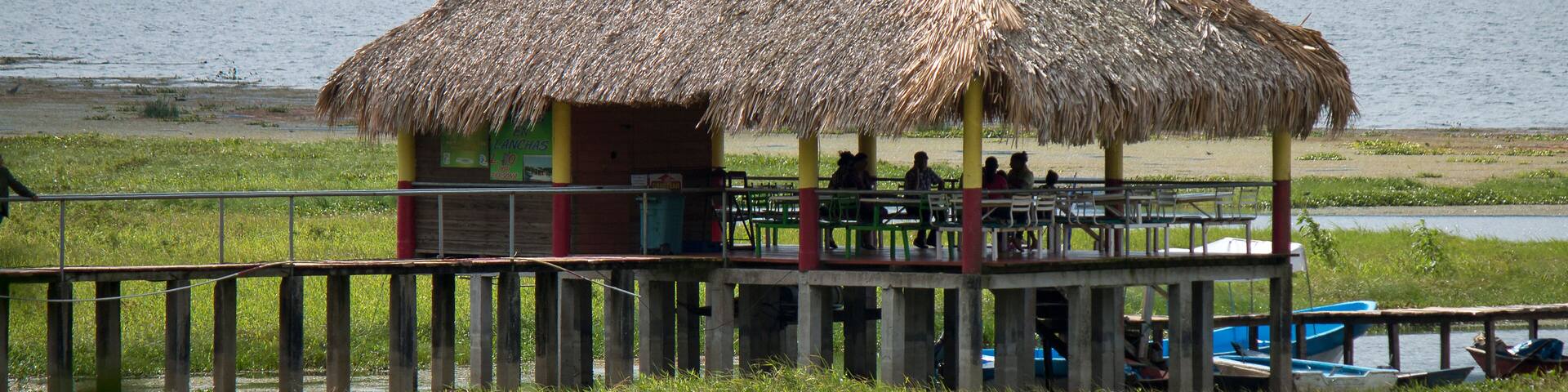 A rural dinning room besides a lake