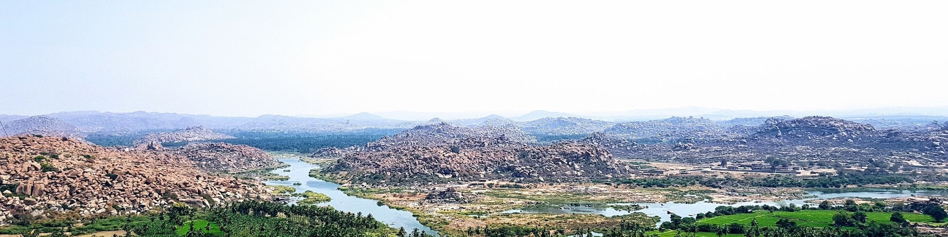 Cross over the river in Hampi to visit the 'hippie island.' Hire a scooter and drive past vibrant rice fields seeking temples. An incredible view of the boulder strewn landscape with its ancient temples and winding river can be seen at the top of Anjaneya Temple.
#india #temples #hampi #landscapes