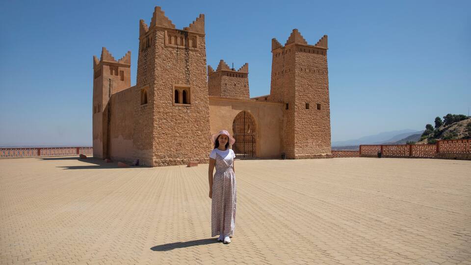 A historic castle with two prominent towers and a large arched entrance.