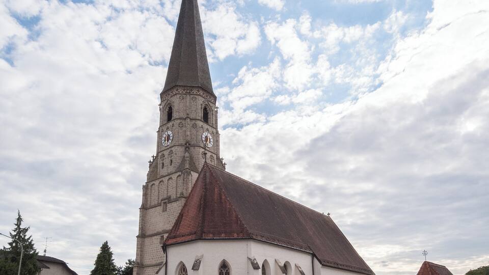 A church with a tall spire and a clock tower.