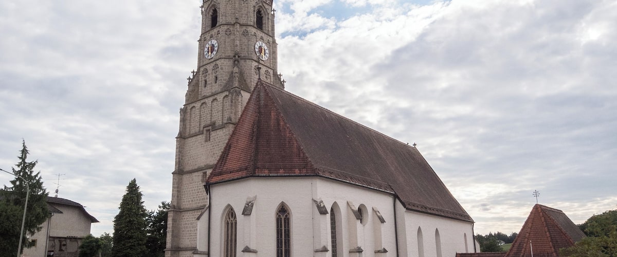 A church with a tall spire and a clock tower.