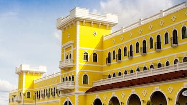 A yellow building with multiple balconies and arched windows.